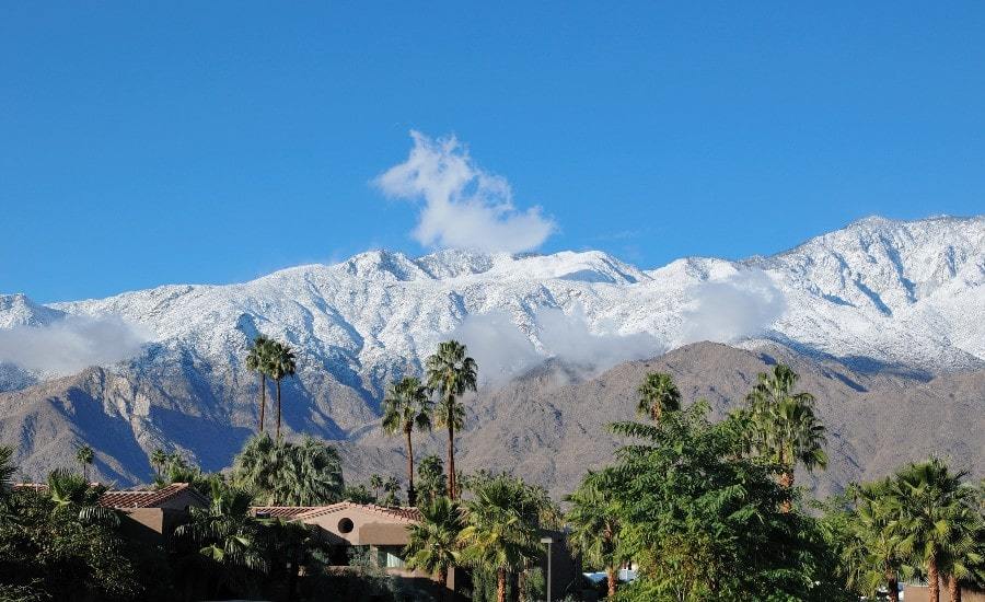View of typical Palm Springs real estate with a snowy mountain behind